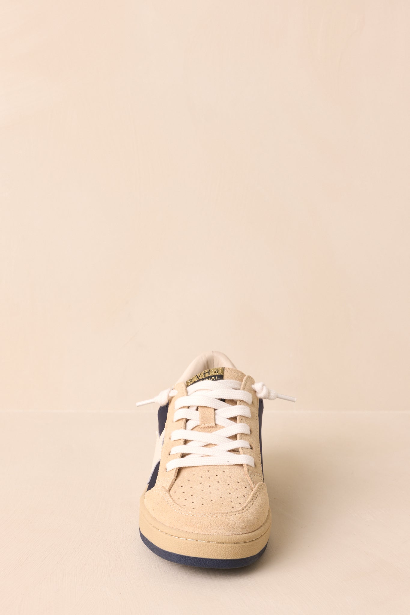 Straight-on front shot showing the perforated toe box, lace structure, and rounded toe.