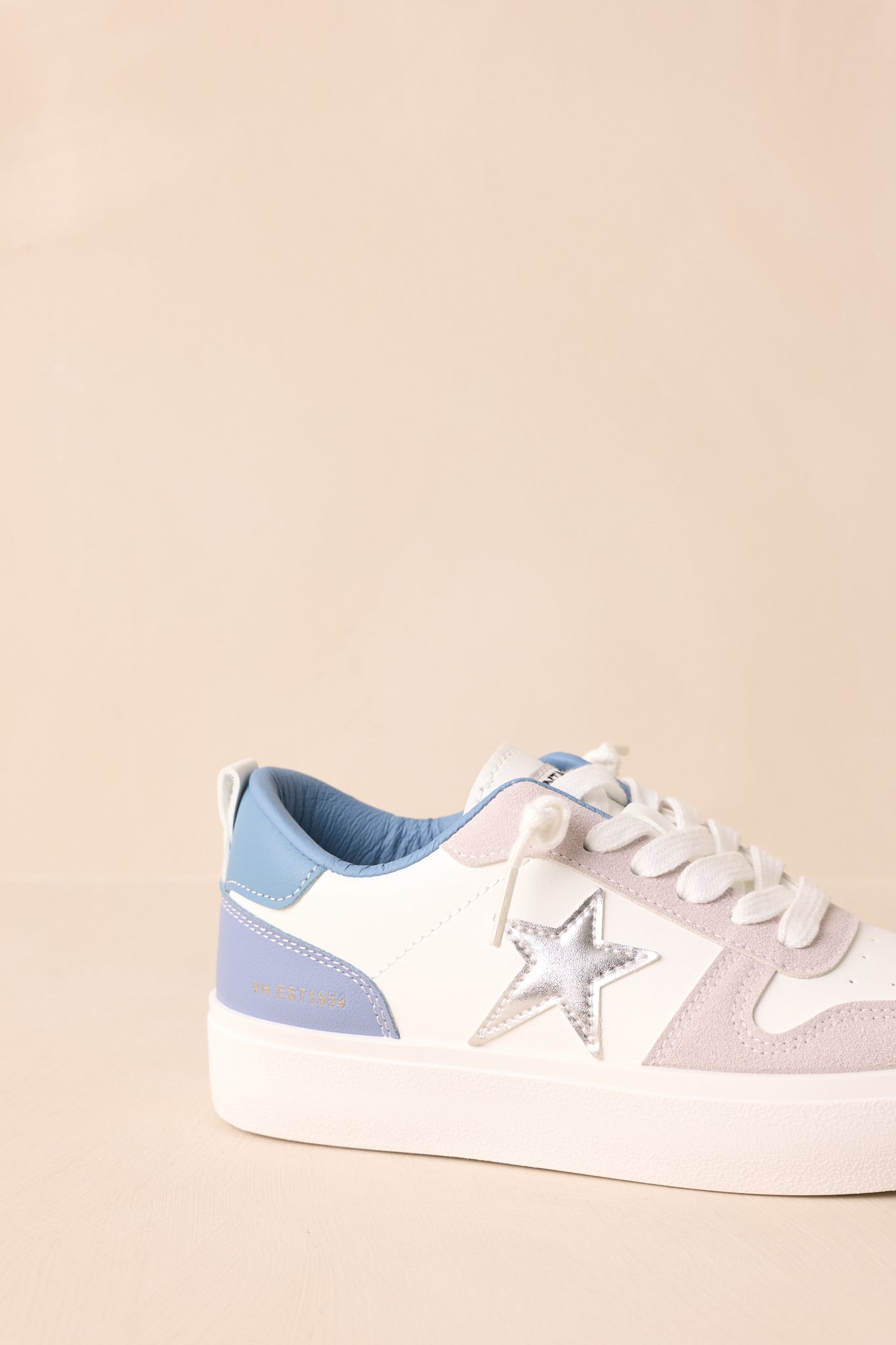 Detailed view of the chunky platform sole and textured suede and leather materials.