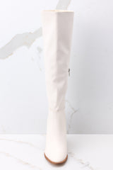 Front view of white boots with subtly pointed toes. 
