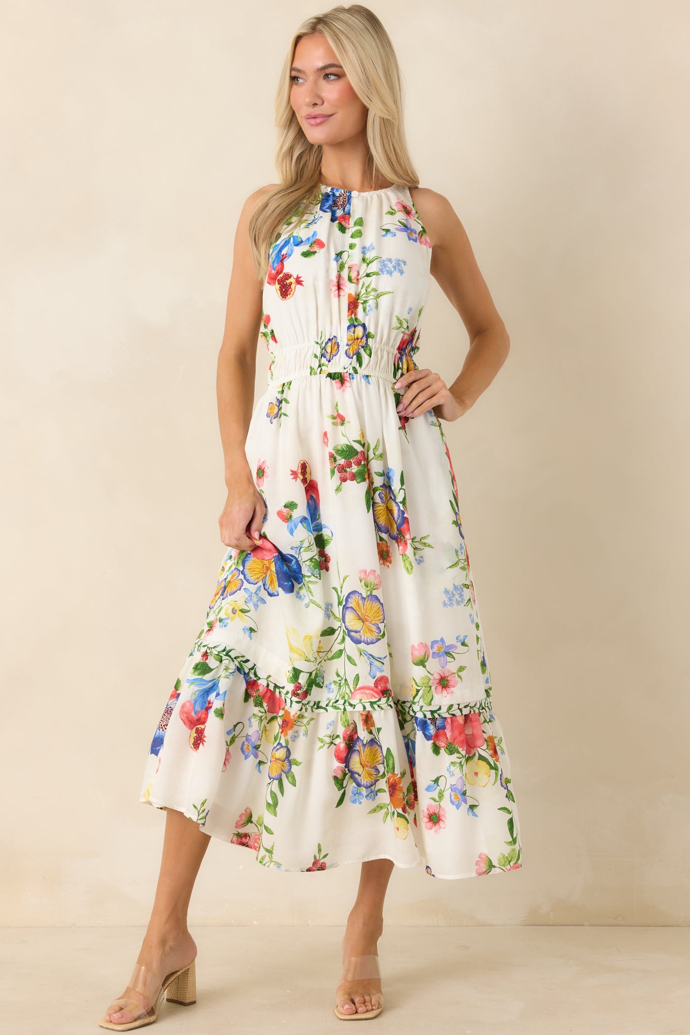 Colorful floral midi dress with fruit details and a relaxed, feminine shape.