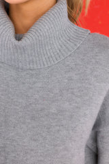 Close up view of this sweater that features a chunky cowl neckline accompanied by ribbed detailing.