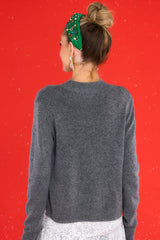 Back view of this pullover sweater that features a ribbed high collar neckline, long sleeves, and ribbed detailing through the hemline and cuffs.