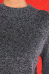 Close up view of this pullover sweater that features a ribbed high collar neckline.