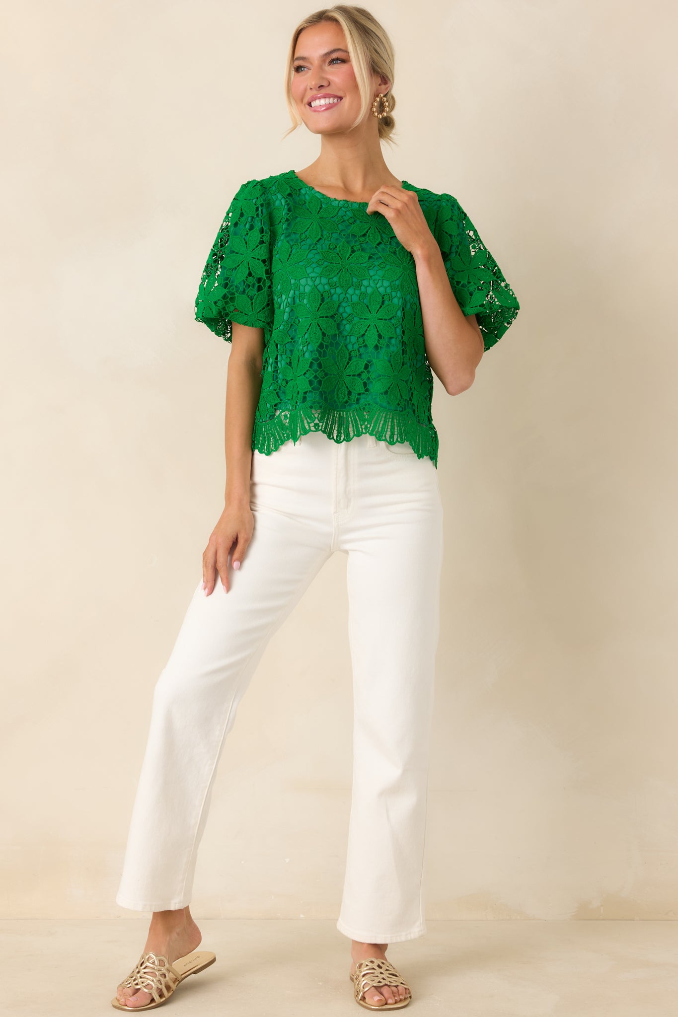 Green floral lace top with classic round neckline styled with white denim jeans.