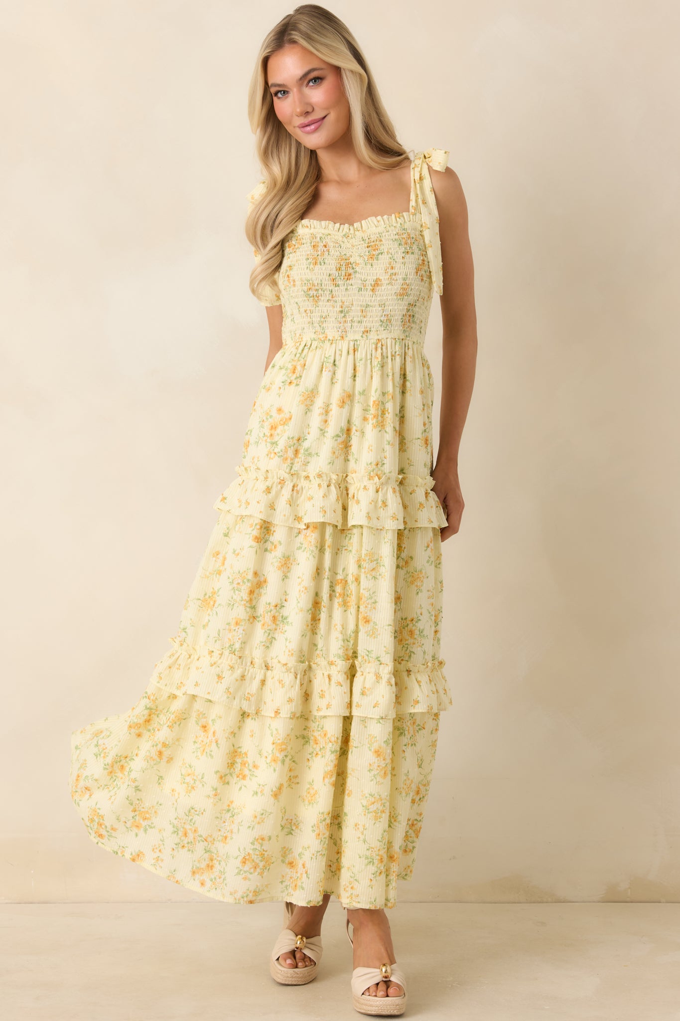 Lightweight floral cotton midi dress featuring a smocked bodice, sweetheart neckline, and tiered ruffle skirt with airy movement.
