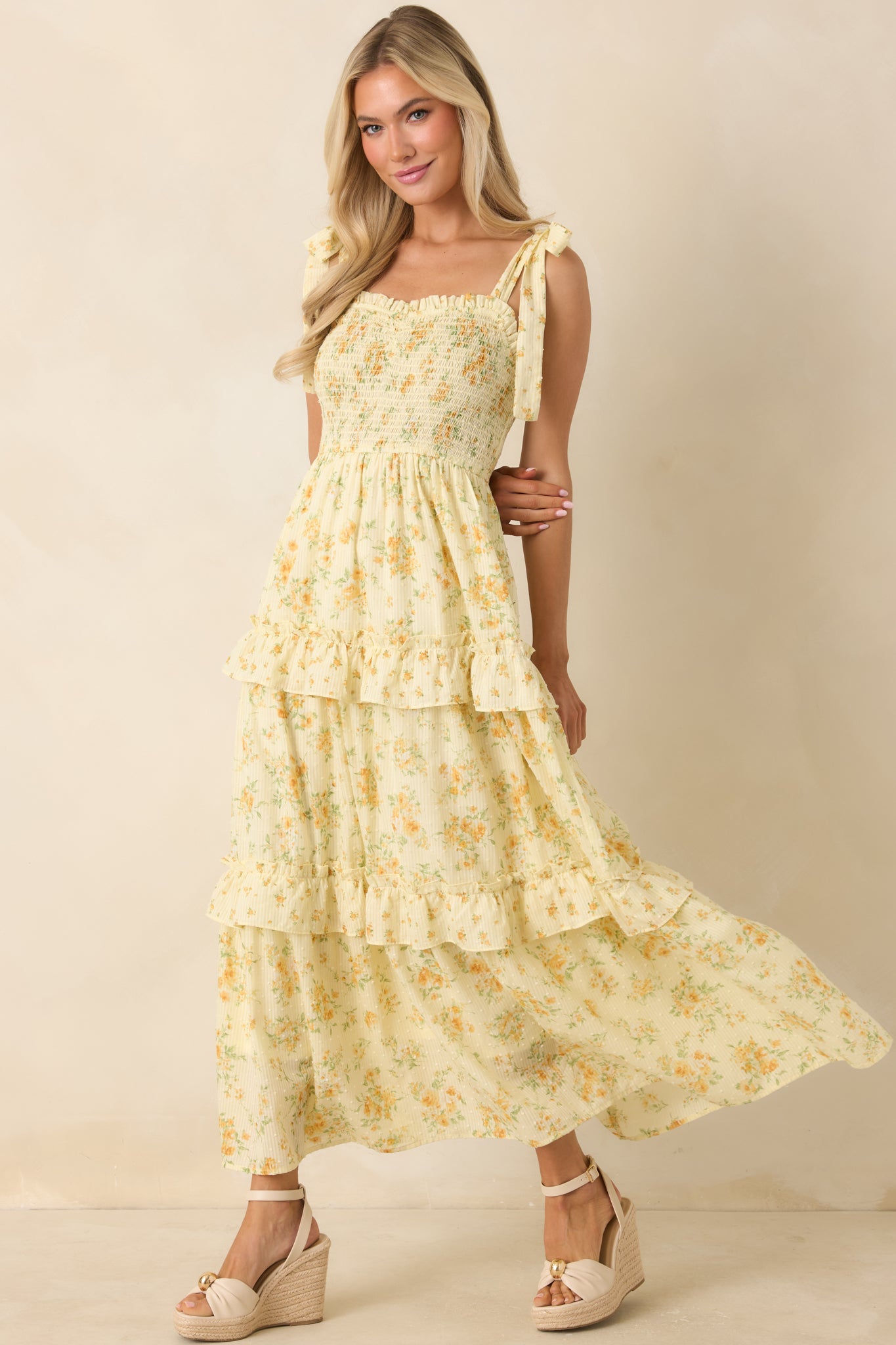 Lightweight floral midi dress featuring tie straps and a softly tiered ruffle skirt.