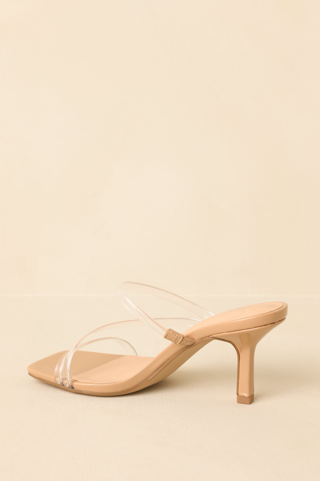 Back view of nude clear strap heels showing the slim structured heel and transparent straps from behind.