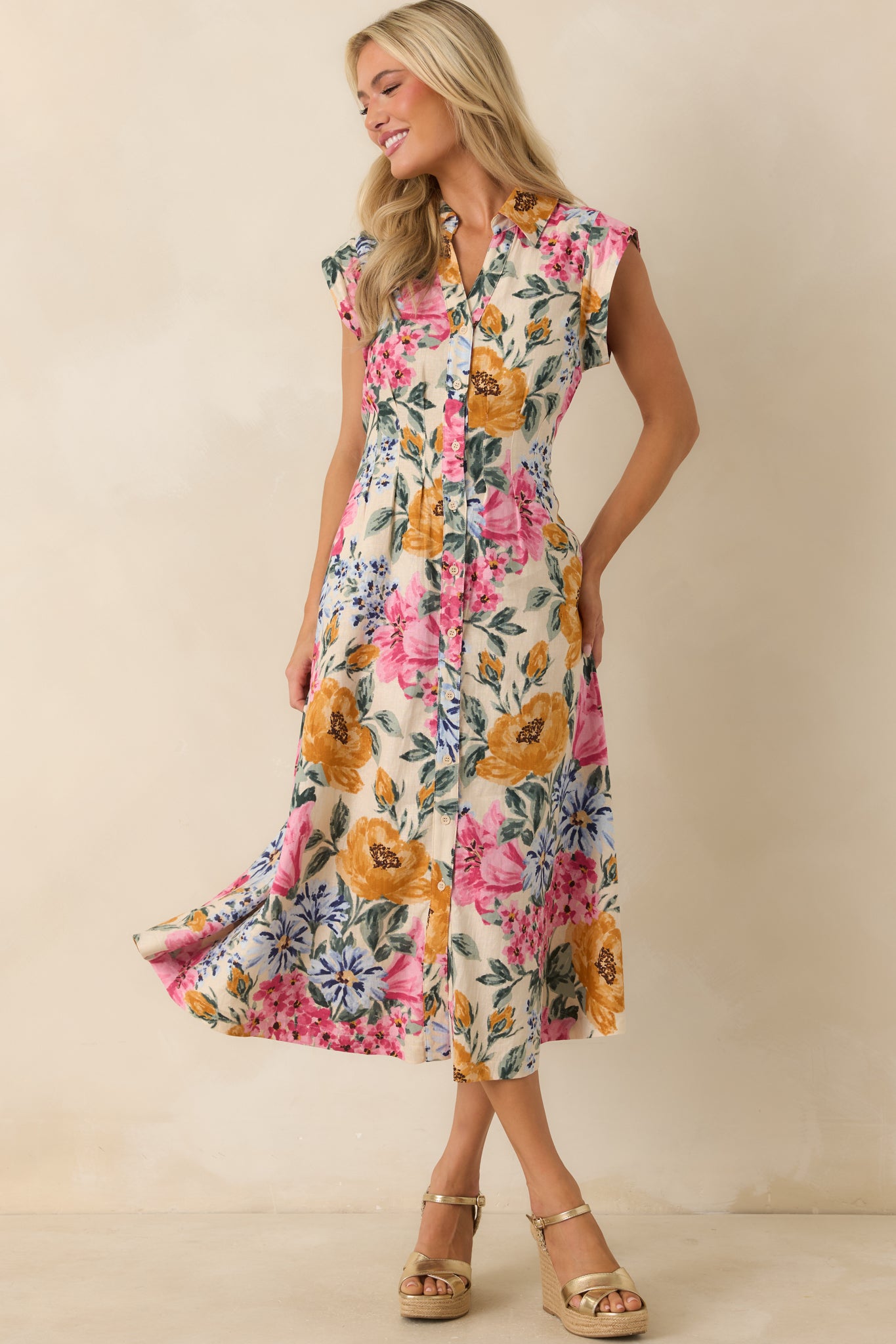 Ivory floral dress with a fitted waist and collared neckline, finished with cap sleeves and a continuous allover botanical print.