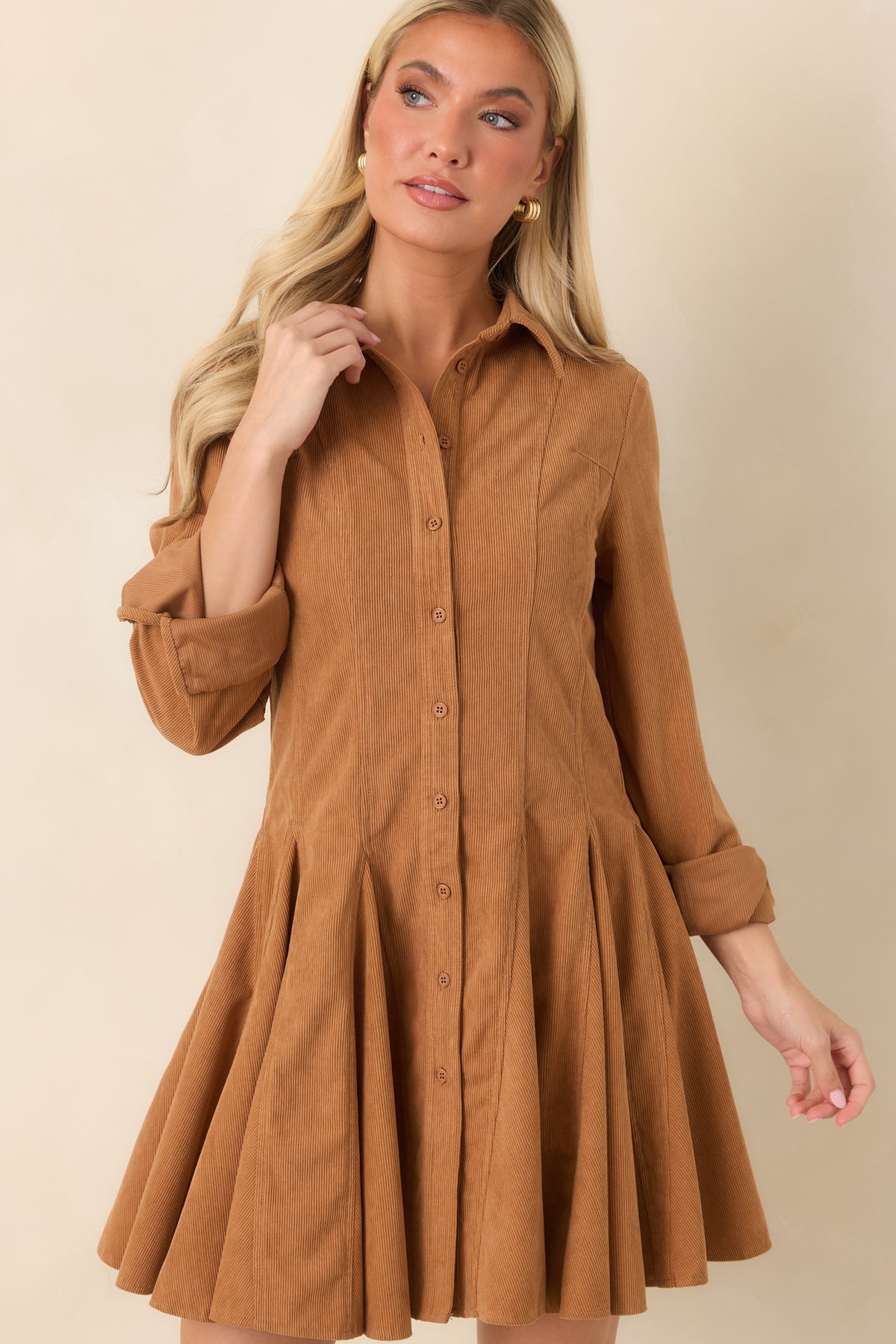 Long sleeves with buttoned cuffs add a classic finish to the warm camel corduroy dress.