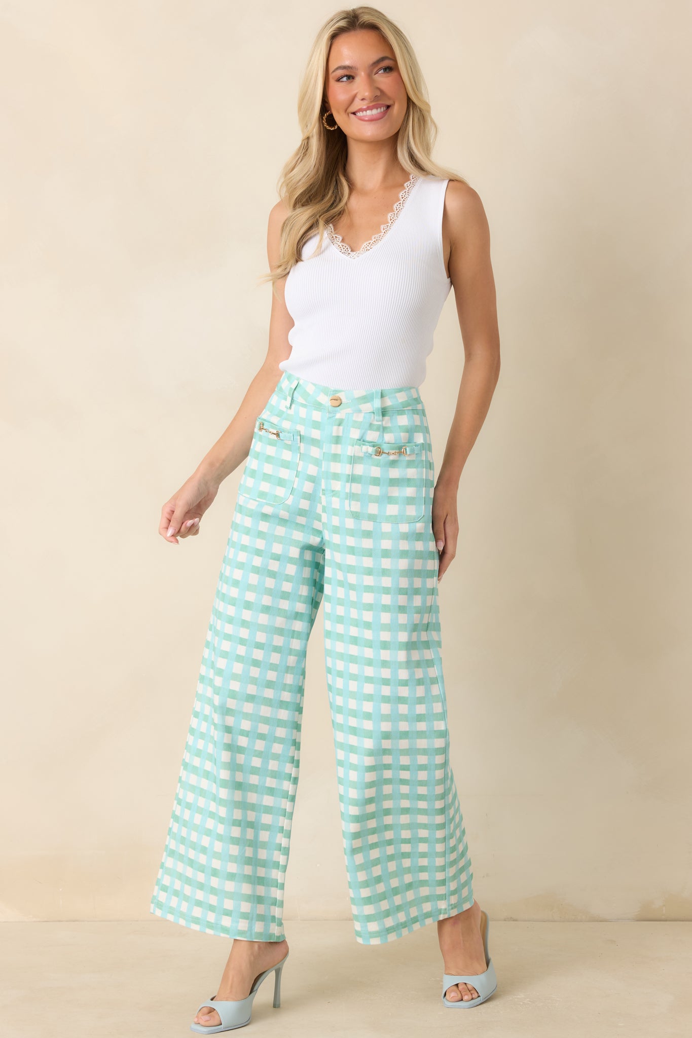 Aqua and mint checkered pants with front patch pockets, decorative gold-tone hardware, and a polished wide-leg design.