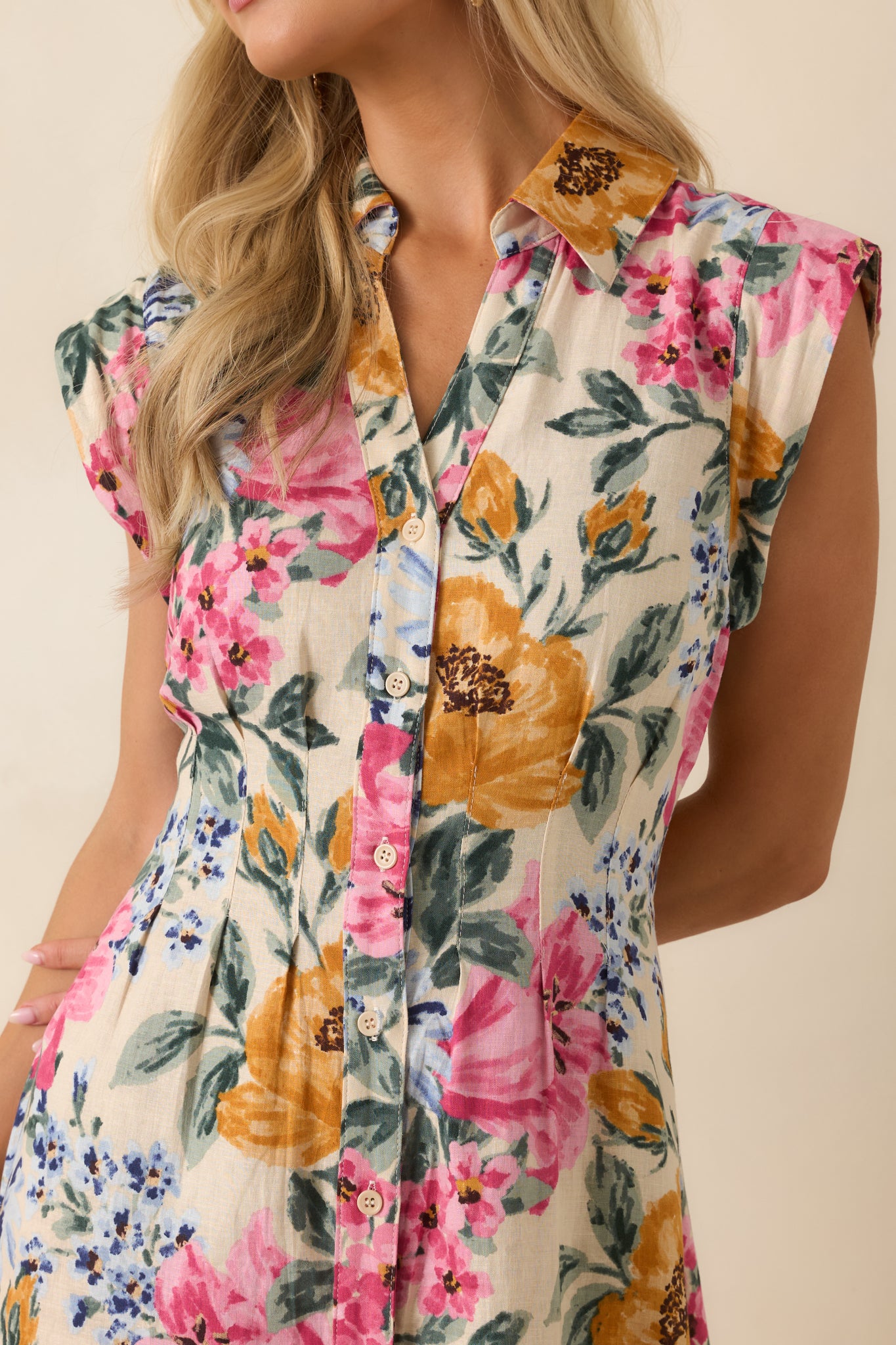 Close view of the floral midi dress emphasizing the collared neckline, button-front detailing, and fine linen-rayon fabric texture.