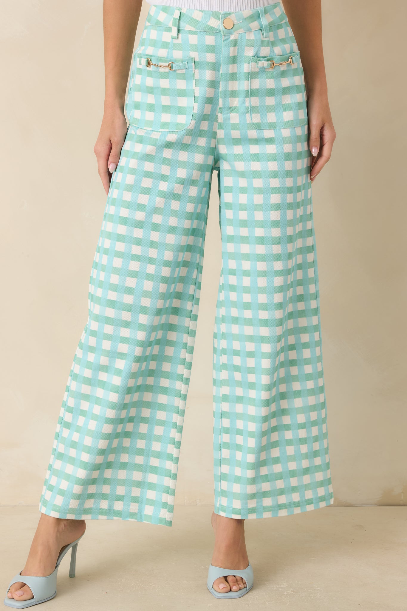 Aqua blue and mint cotton pants featuring a classic gingham pattern, belt loops, and structured tailoring details.
