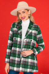 Front view of this coat that showcases a plaid pattern in shades of white, red, and green.
