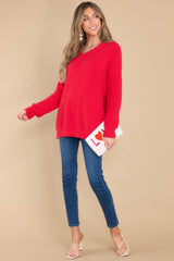 Full body view of this sweater that features a v-neckline and an oversized look.