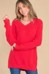 Front view of this sweater that features a v-neckline, small slits up the sides at the bottom of the sweater, and an oversized look.