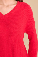 Close up view of this sweater that features a v-neckline and knit pattern.