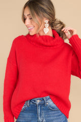 This red sweater features a high chunky turtle neck, ribbed detailing on the cuffs and bottom hem, and a super soft fabric.