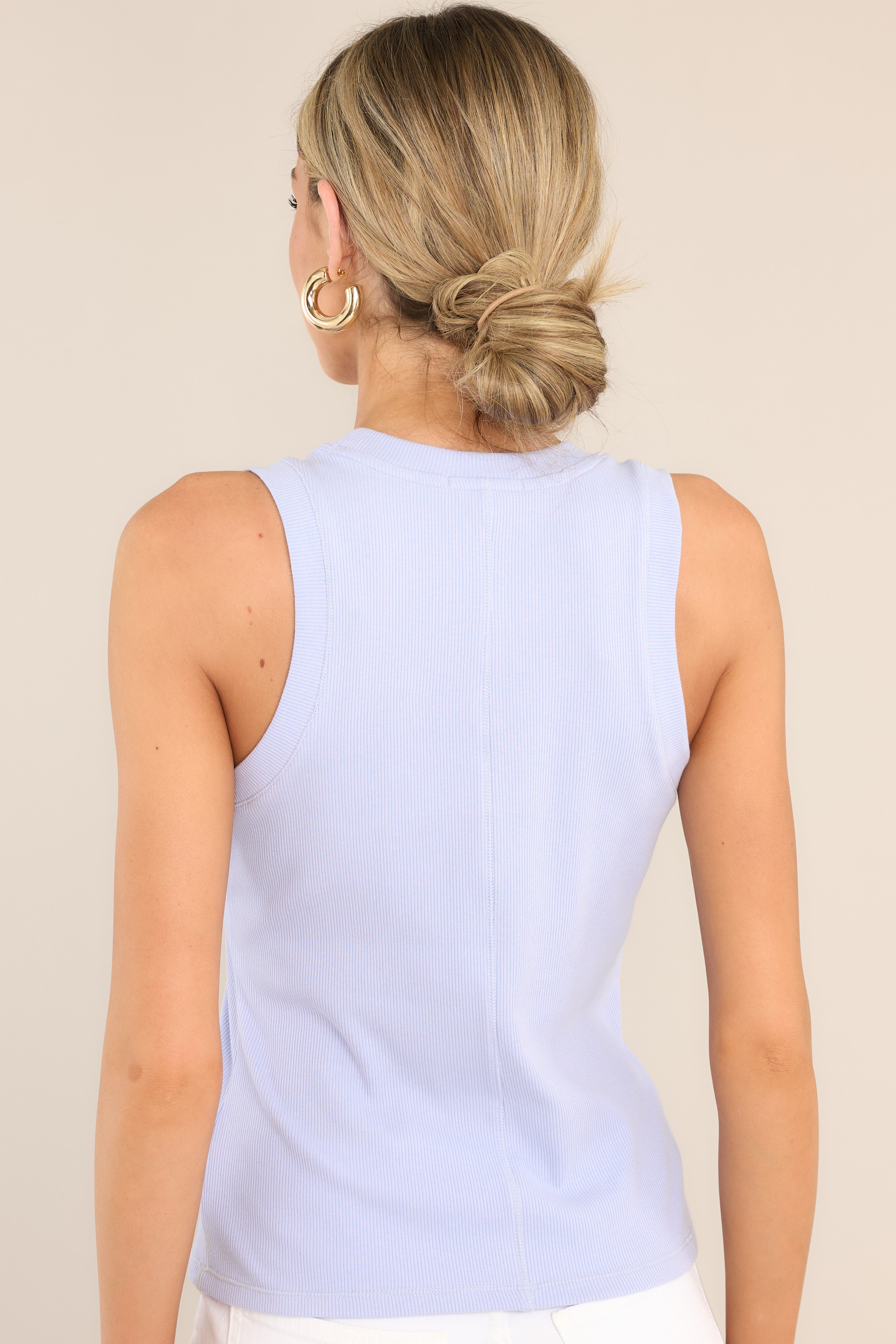 Back view of this tank top that features a scoop neckline and ribbed texturing throughout.