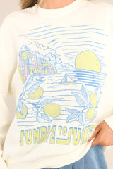 Close up view of this sweatshirt that features a crew neckline, dropped shoulders, a summery graphic that says 