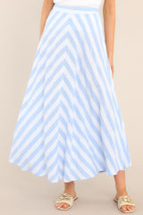 Front view of this skirt that features a high waisted design, a functional zipper and hook closure in the back, a diagonal striped pattern, and a flowy fabric.
