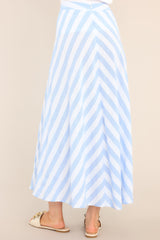 Back view of  this skirt that features a high waisted design, a functional zipper and hook closure in the back, a diagonal striped pattern, and a flowy fabric.