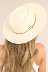 Back view of this hat that features a round telescope crown with a flat brim and a leather chinstrap around the crown.