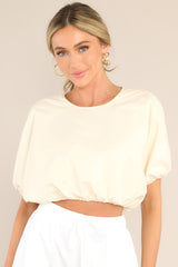 Front view of this top that features a crew neckline, elastic cuffed dolman sleeves, and an elastic cuffed cropped hemline.