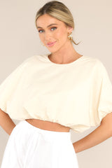 Front view of this top that features a crew neckline and elastic cuffed dolman sleeves.