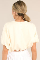 Back view of this top that features a crew neckline, elastic cuffed dolman sleeves, and an elastic cuffed cropped hemline.