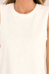 Close up view of this tank top that features a crew neckline, a super soft terry cloth fabric, ribbed texturing, and a split hemline.