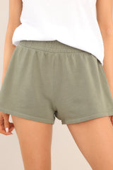Close up view of these shorts that feature a mid-rise smocked waistband and a breathable fabric.