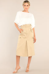 A beige, cargo, midi skirt featuring a belt and functional pockets.