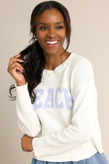 Front view of  this sweater that features a ribbed crew neckline, varsity style wording across the chest, and ribbed cuffed long sleeves.