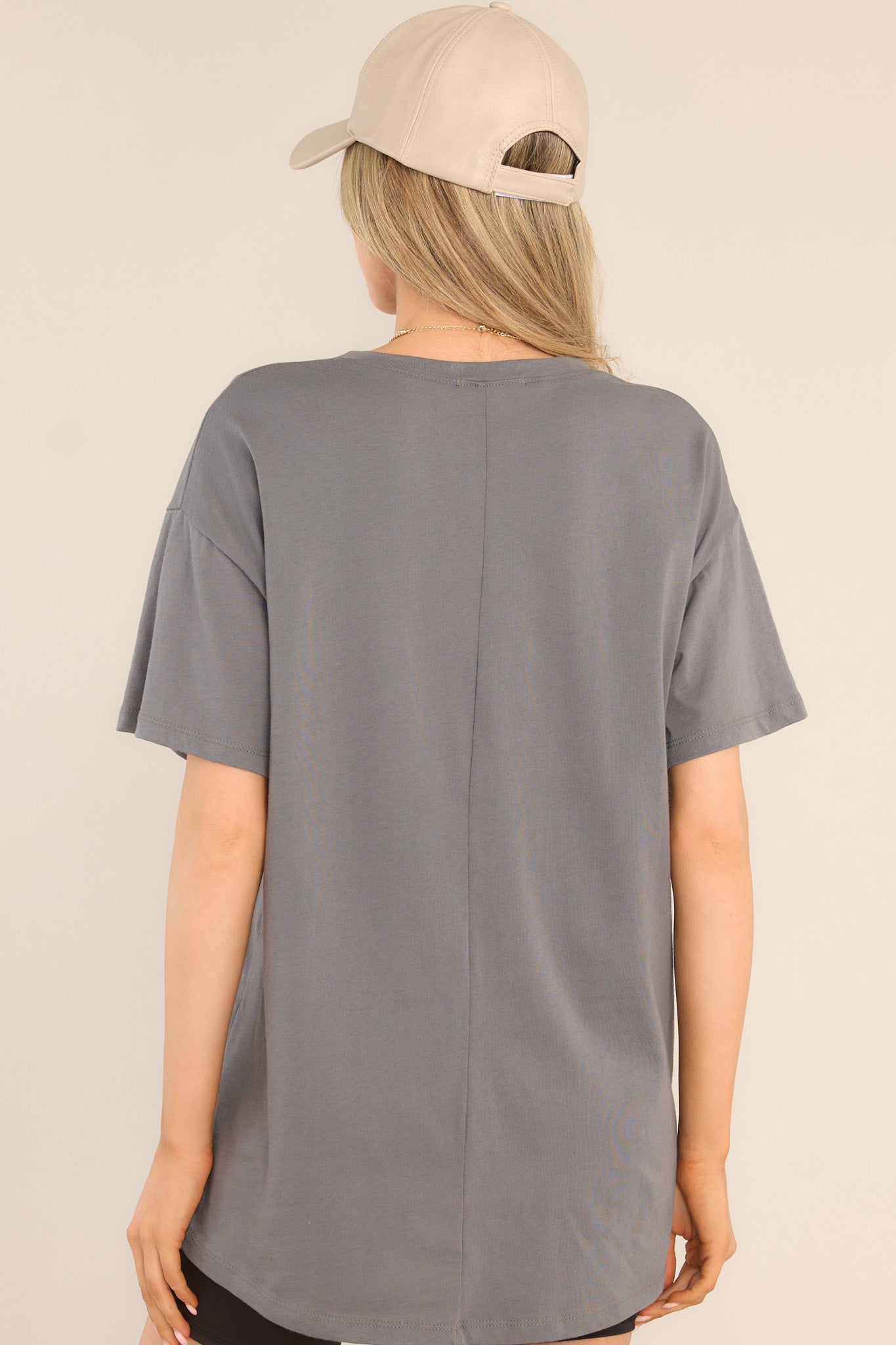 Back view of this top that features a crew neckline, dropped shoulders, center seam down the back and short sleeves.