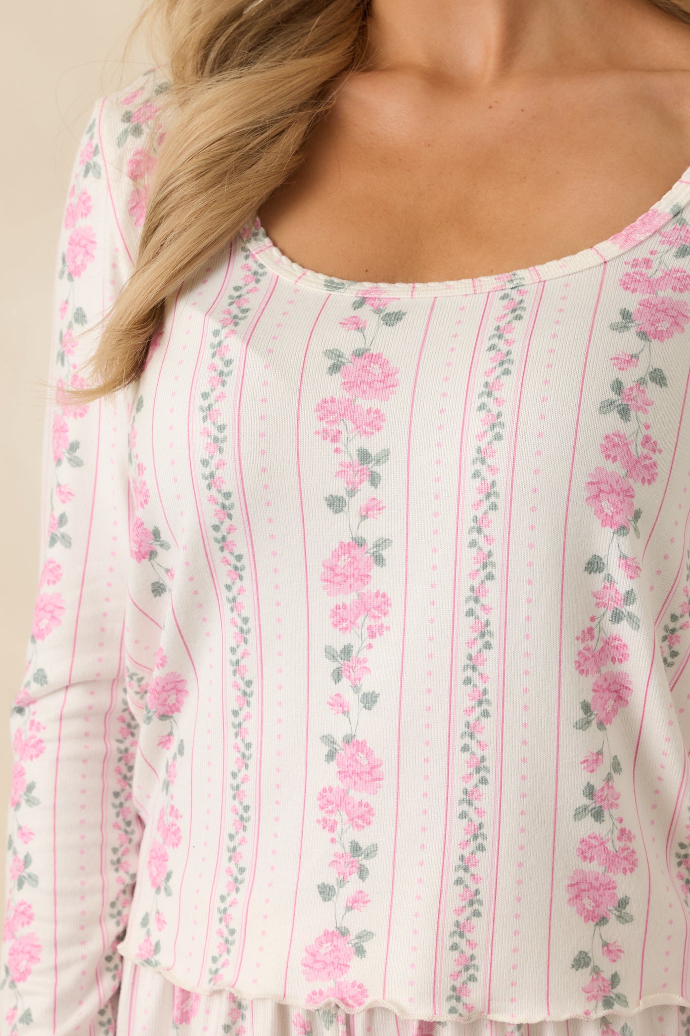 Detailed look at the textured ivory knit fabric with pink and green floral stripe patterning.