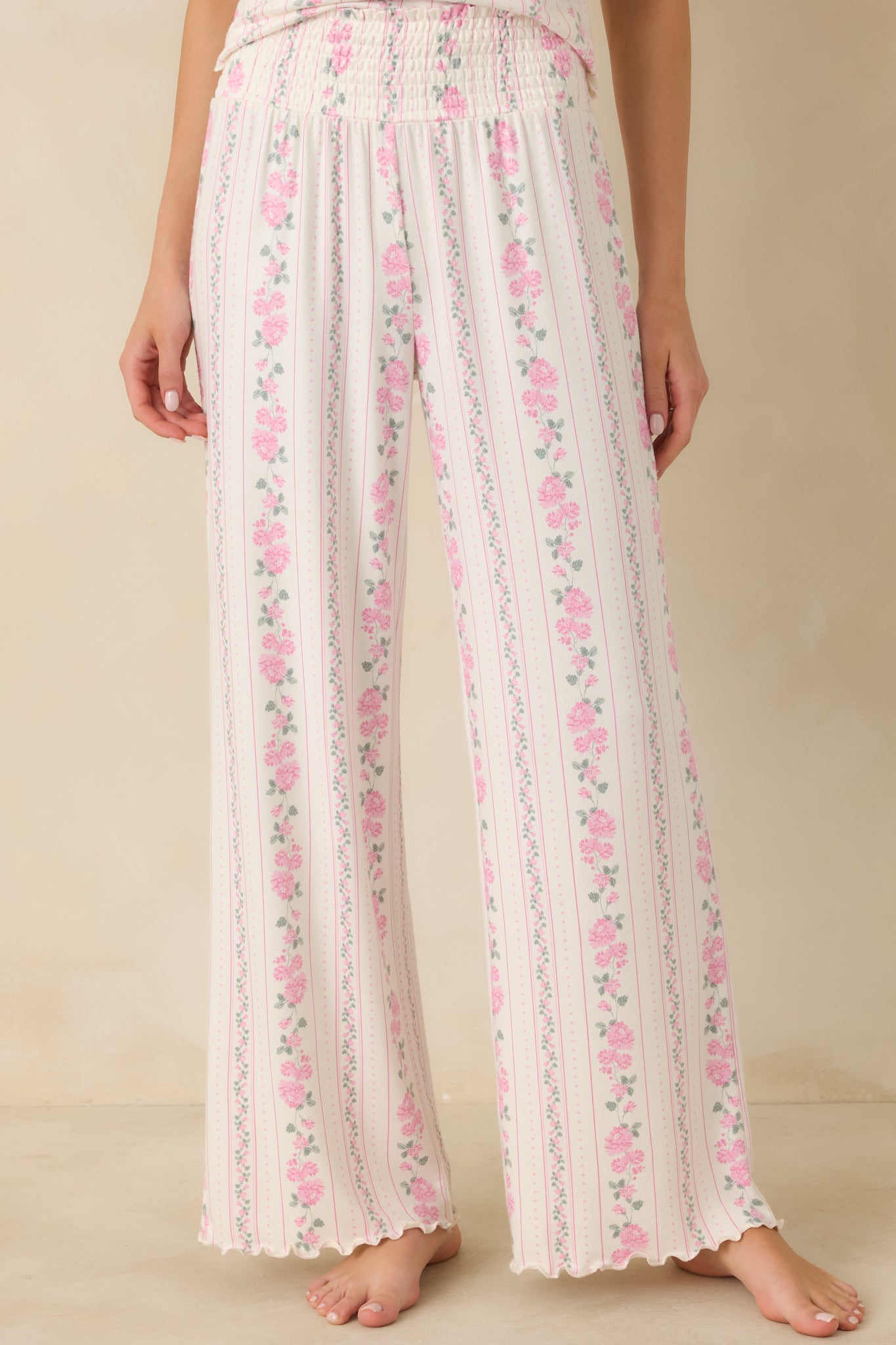 Focused view of the ivory woven fabric showing vertical pink floral striping and smooth texture.