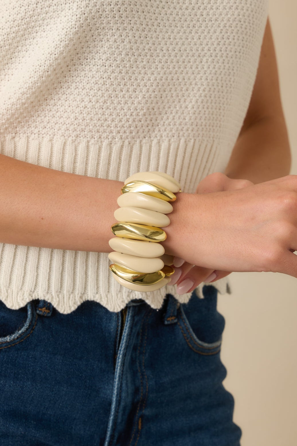 Close view of the ivory sculptural links and gold accents on the elastic stretch bracelet.