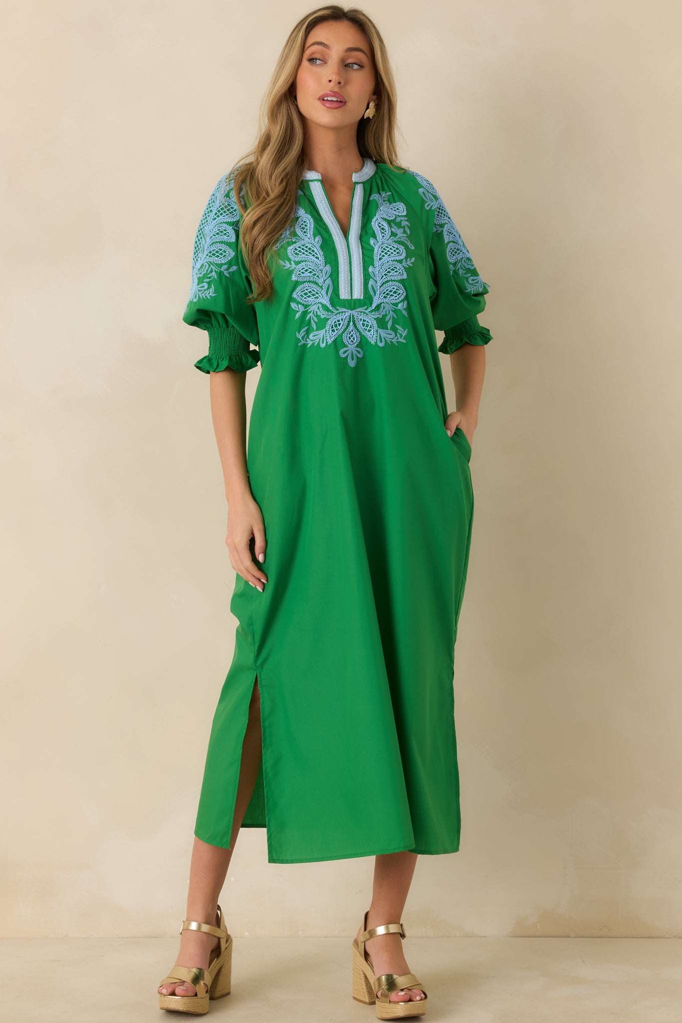 Green maxi dress featuring light blue embroidered detailing across the bodice and relaxed silhouette.