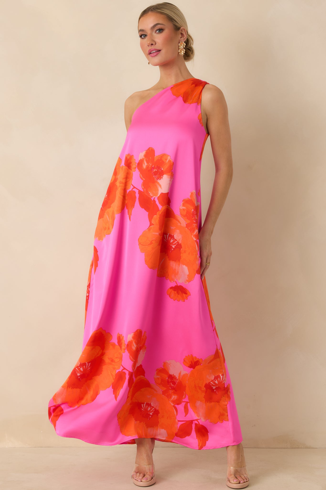Flowy pink satin maxi dress featuring functional pockets and a fully lined silhouette.