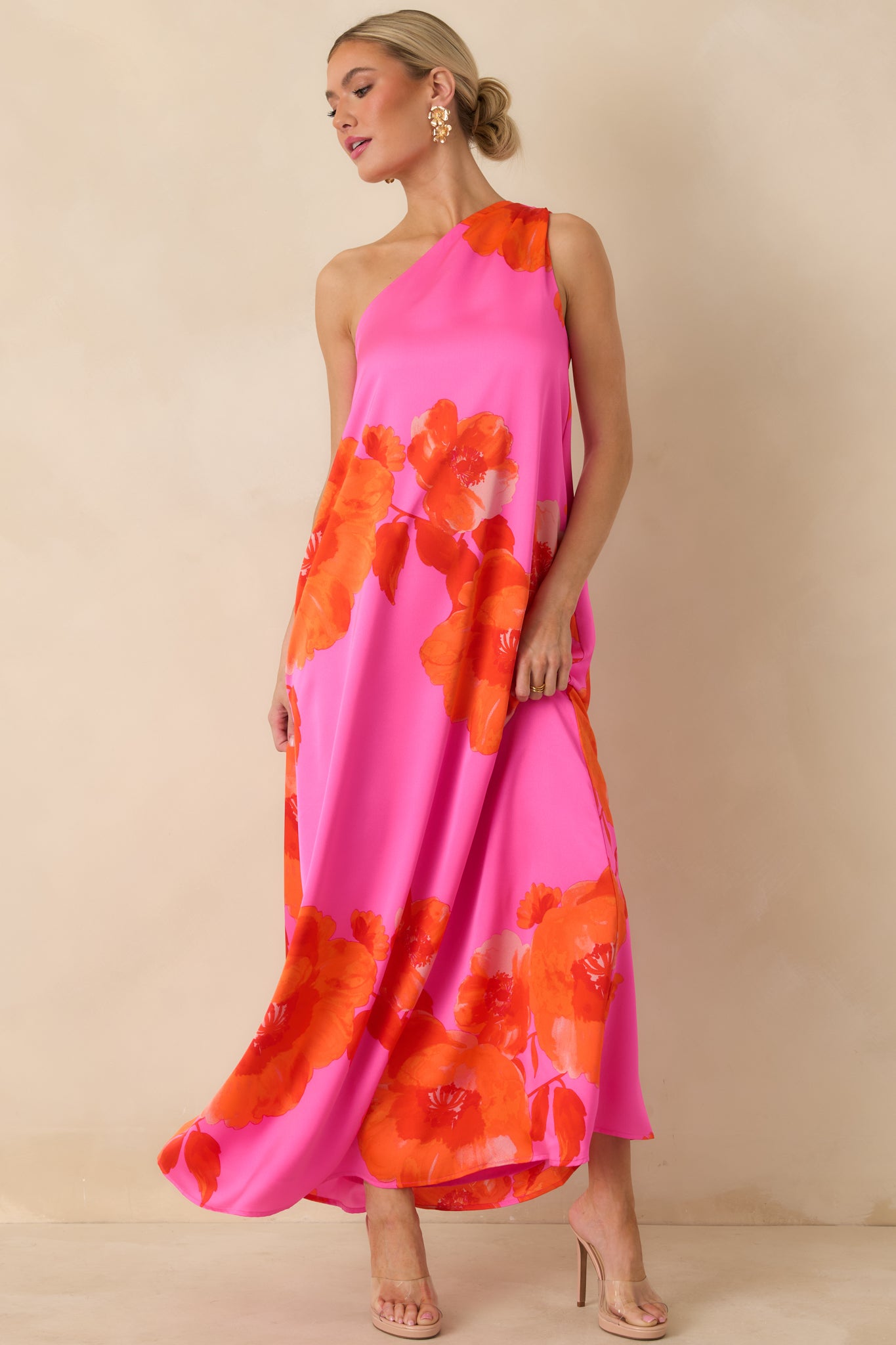 Pink floral maxi dress showcasing a draped one-shoulder design and elegant, floor-length flow.
