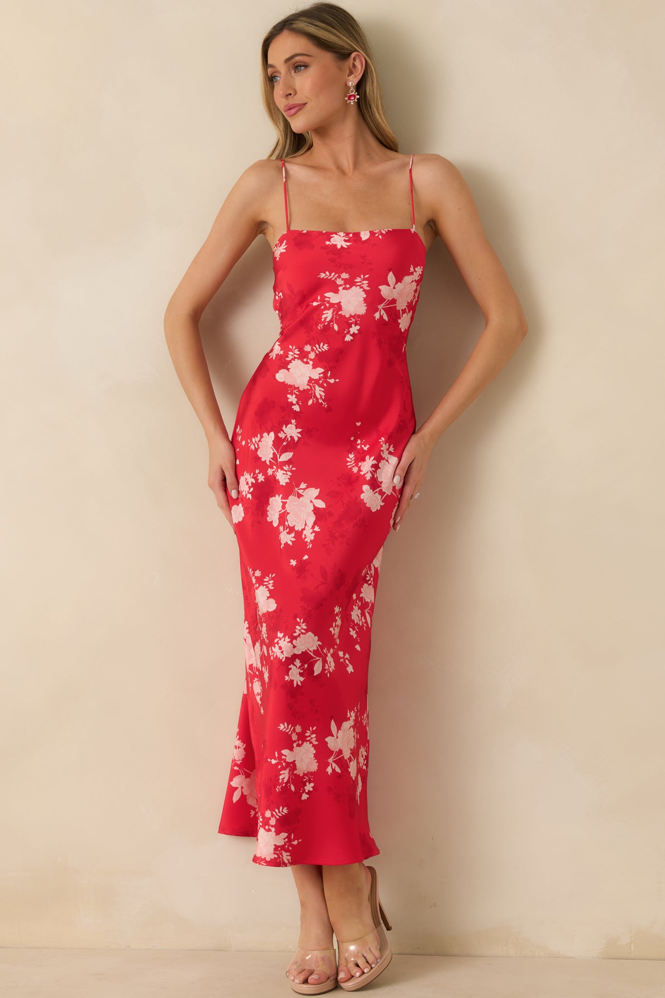 Red floral maxi dress with a fitted bodice, adjustable straps, and a flowing skirt for an elegant, comfortable fit.