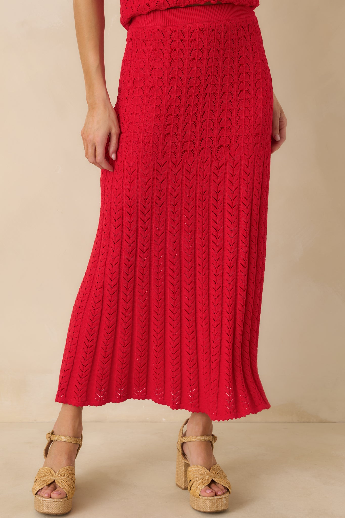 Detailed view of the textured knit fabric throughout the red sweater skirt.