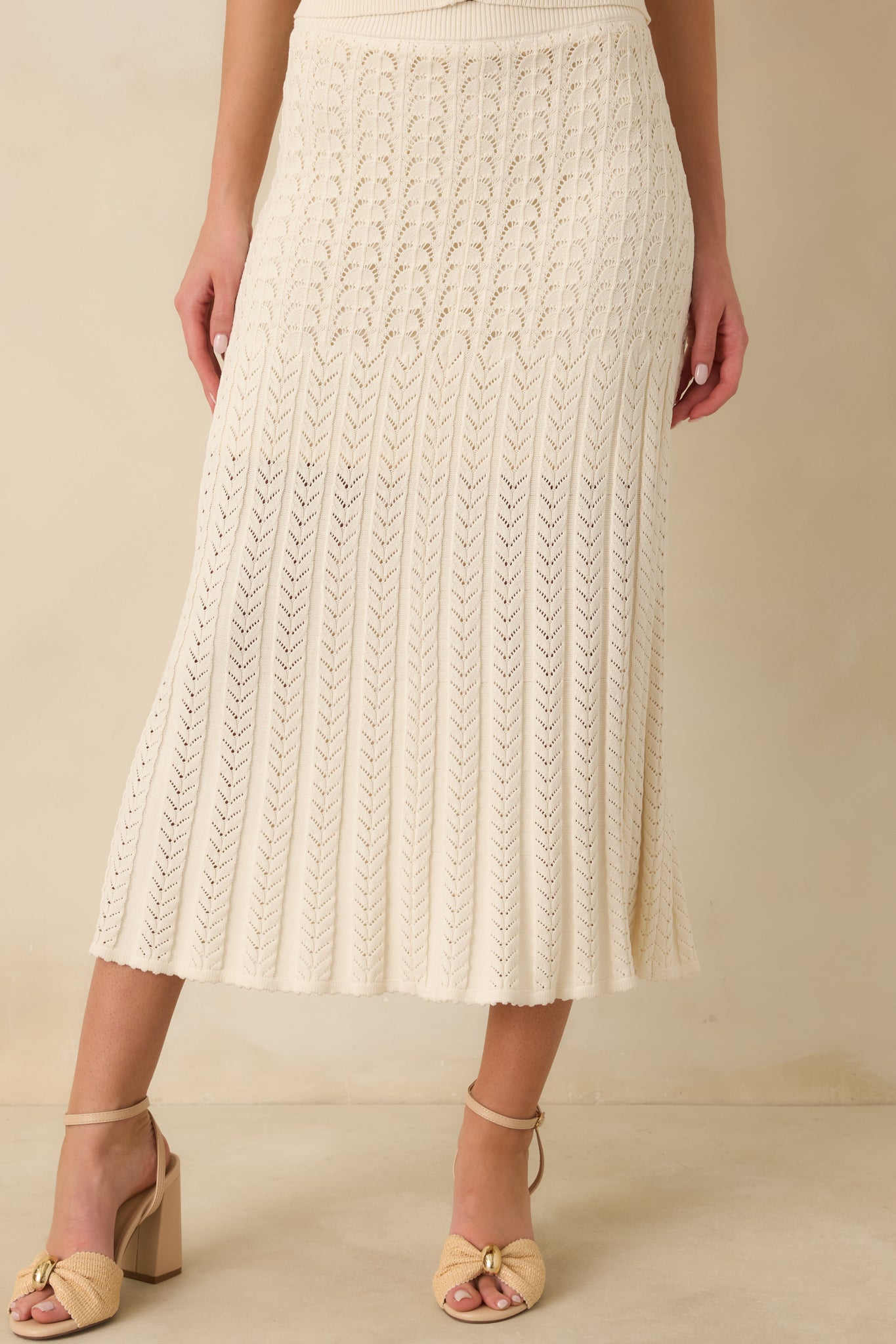 Ivory knit skirt fabric shown with subtle texture and flexible stretch.
