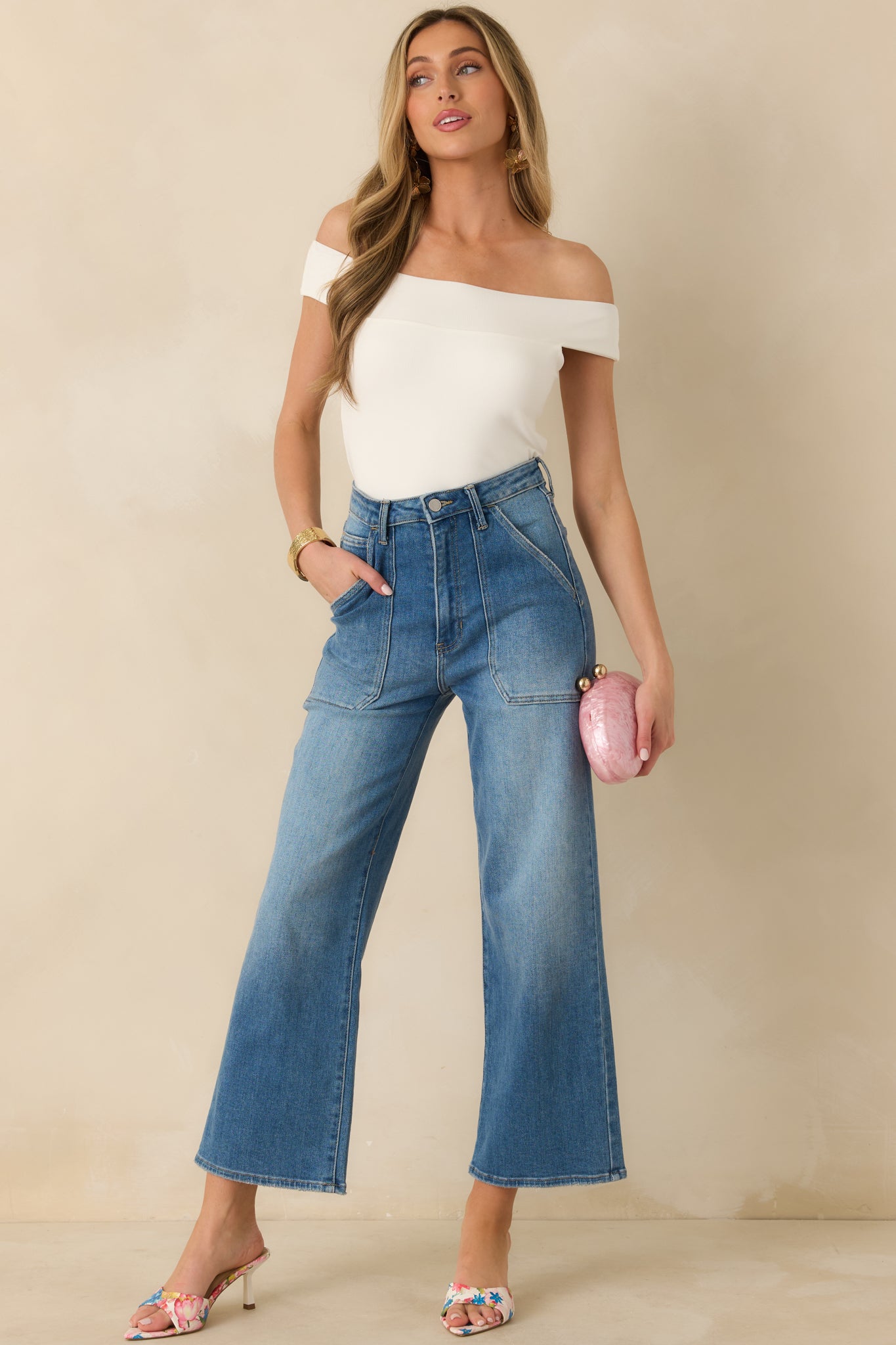 Ivory off-shoulder top designed with stretchy fabric for a comfortable, streamlined look.