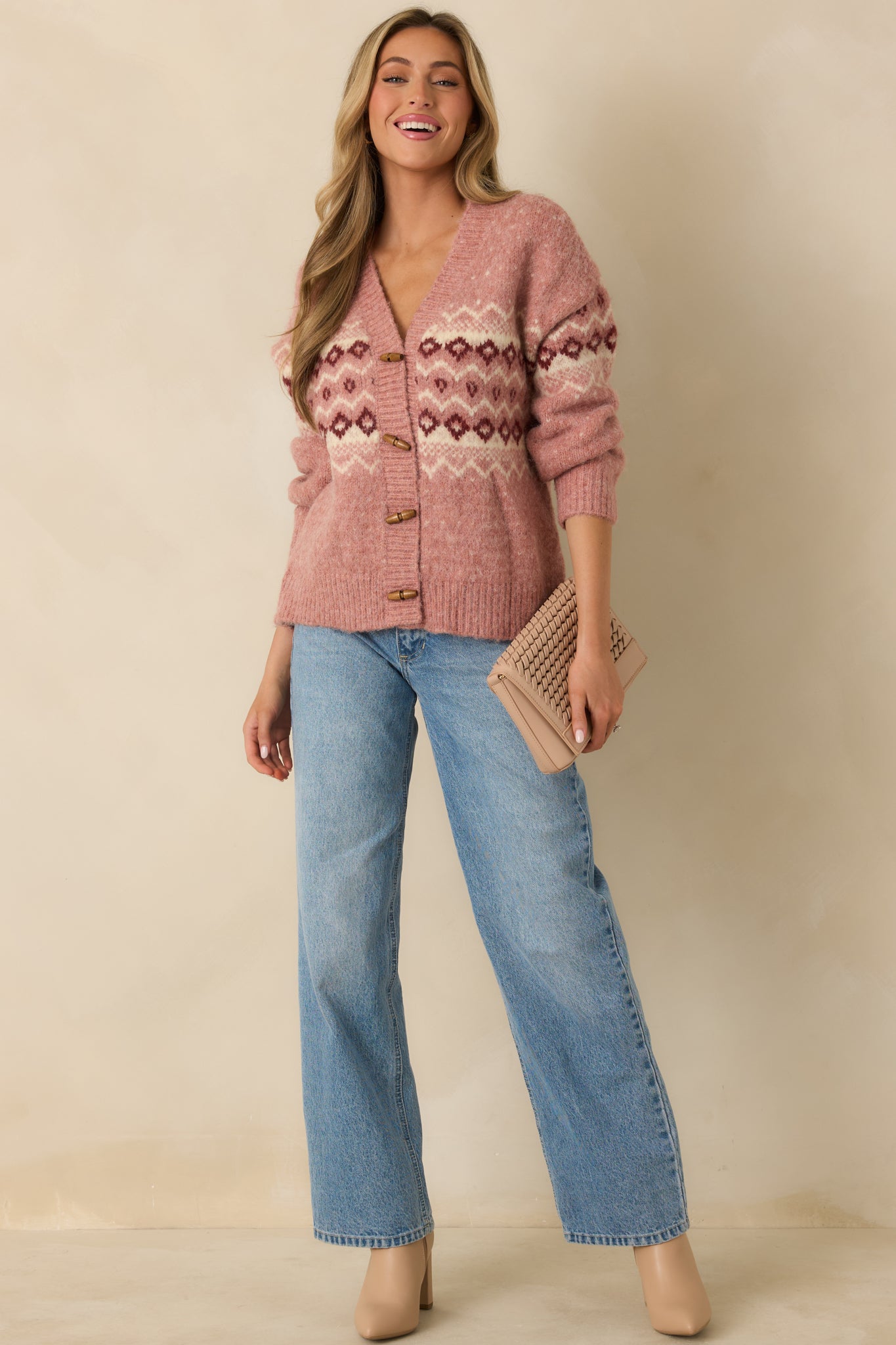 Rose pink Fair Isle cardigan with long sleeves, V-neck design, and relaxed knit silhouette.