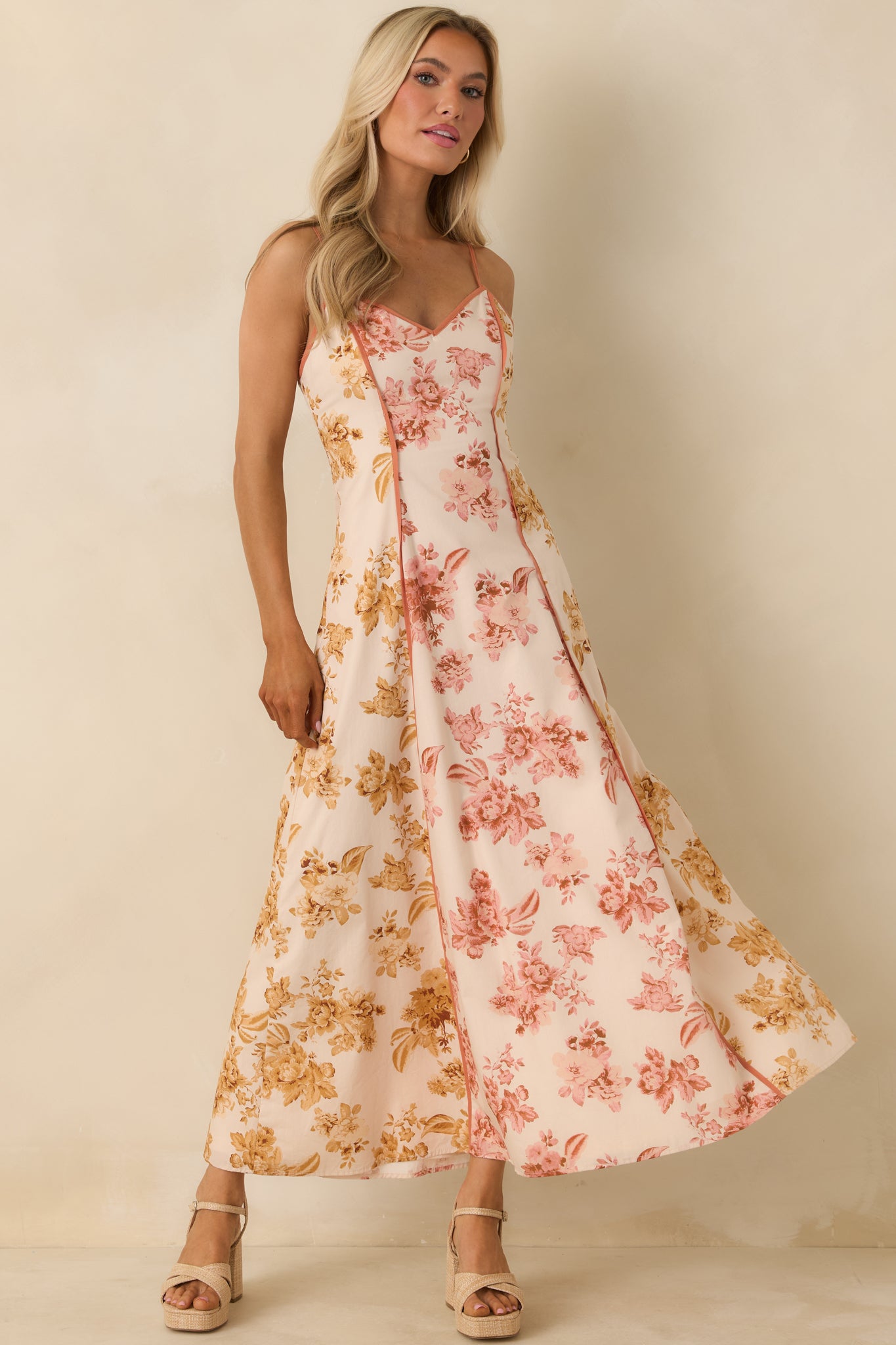 Front view of floral maxi dress featuring adjustable spaghetti straps and flowing silhouette.