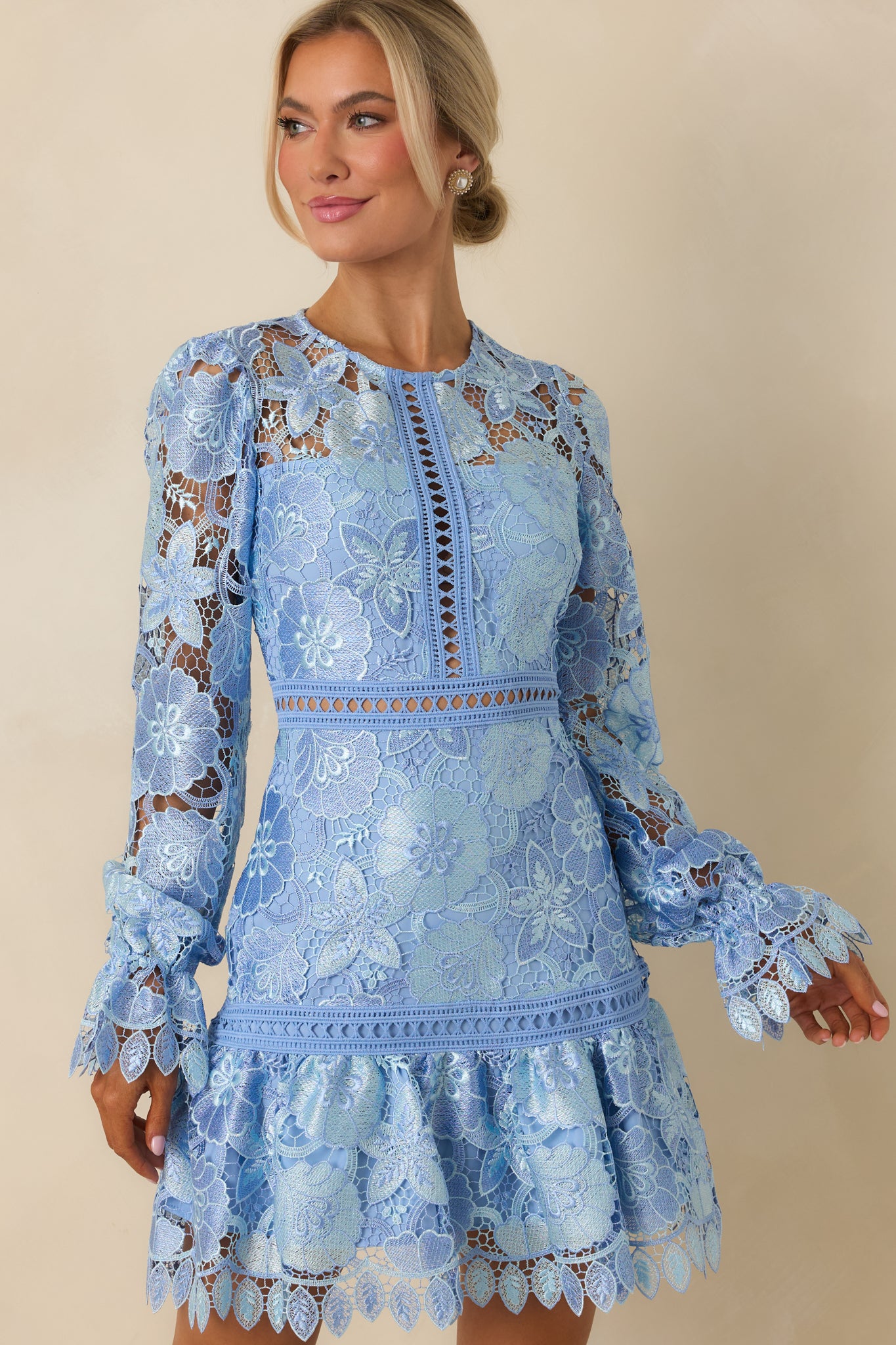 Close cropped view focusing on fabric transparency and elastic cuffs of mini dress.