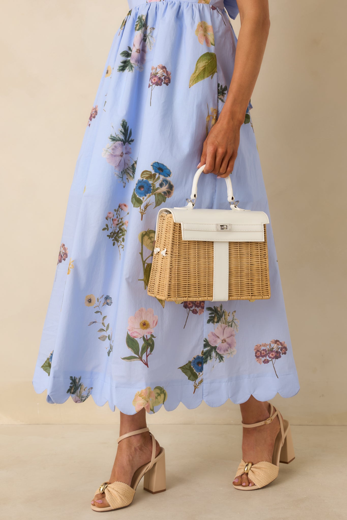 Full view of white structured handbag with woven exterior, smooth faux leather trim, and top handle.