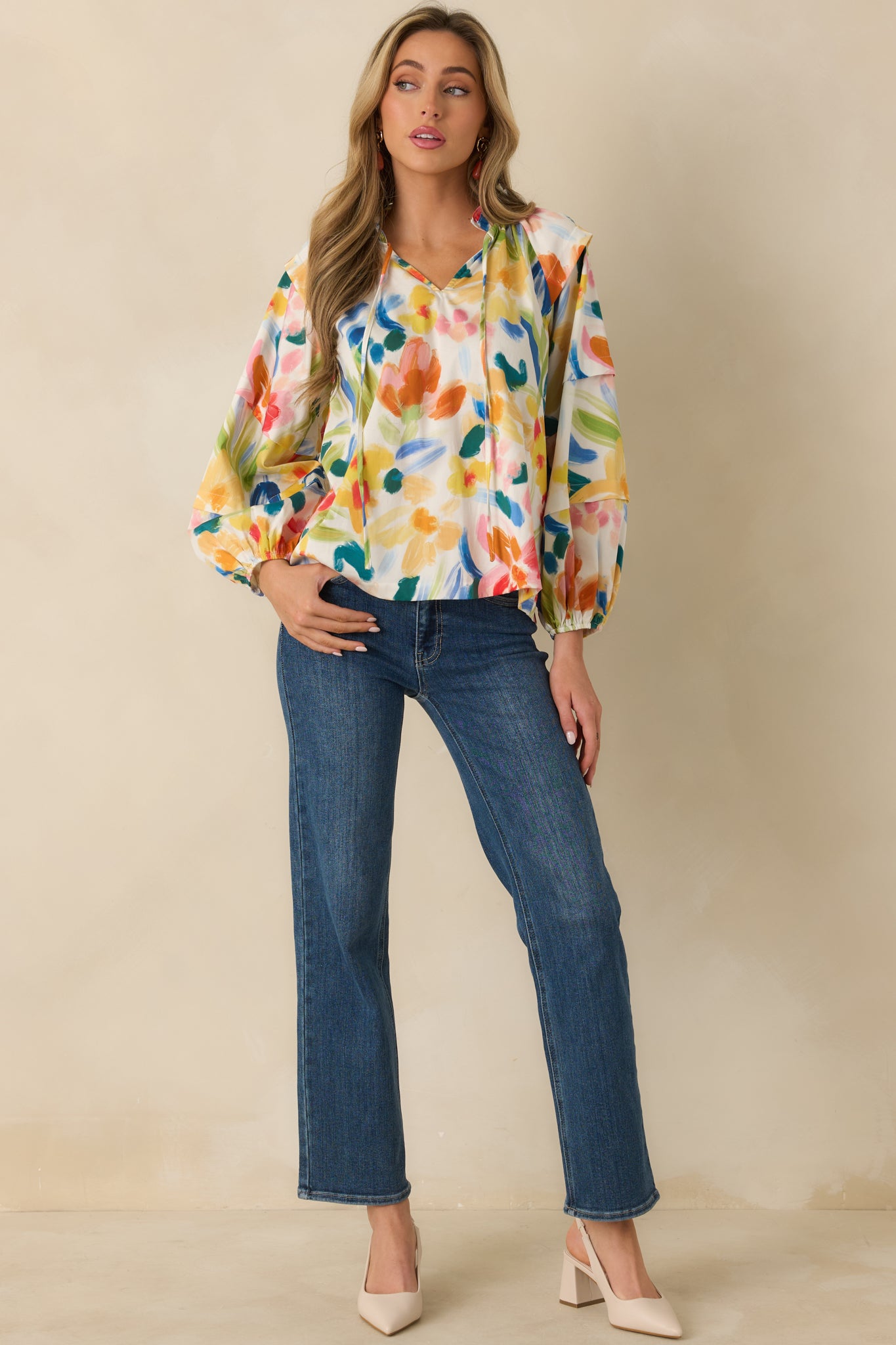 Relaxed-fit floral top with a split neckline, elastic cuff sleeves, and an easy flowing silhouette.