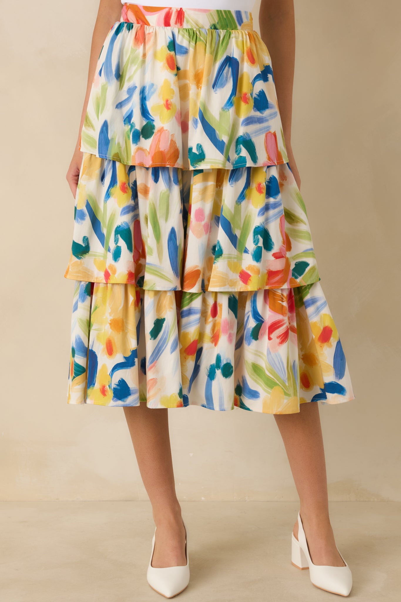 Multicolored cotton midi skirt with an abstract floral print, high-rise elastic waistband, and flowy tiered silhouette.